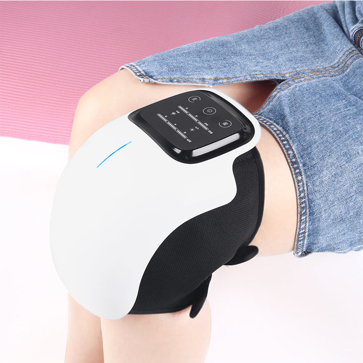 White cordless knee massager wrapped round a knee