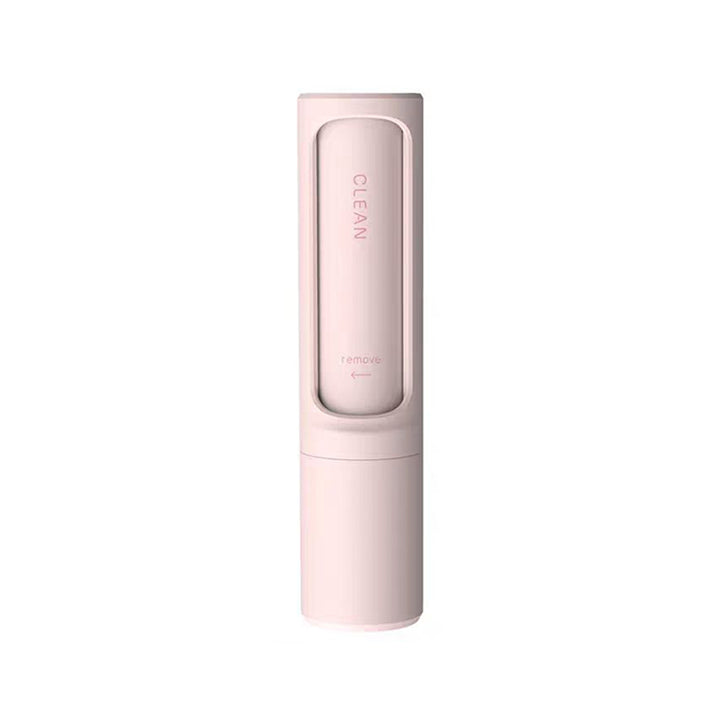 Pet hair remover brush on grey sofa