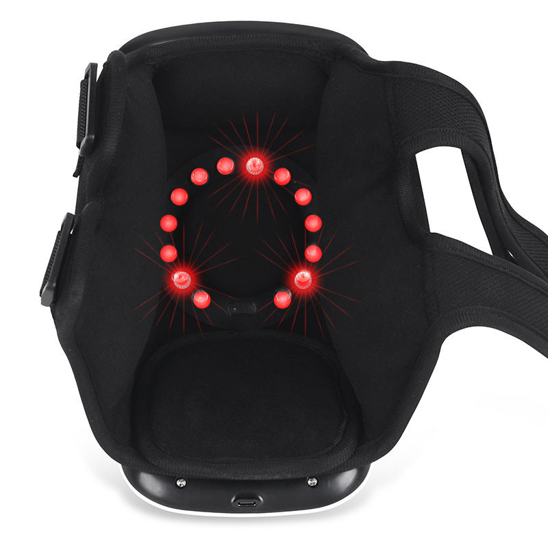 White cordless knee massager wrapped round a knee
