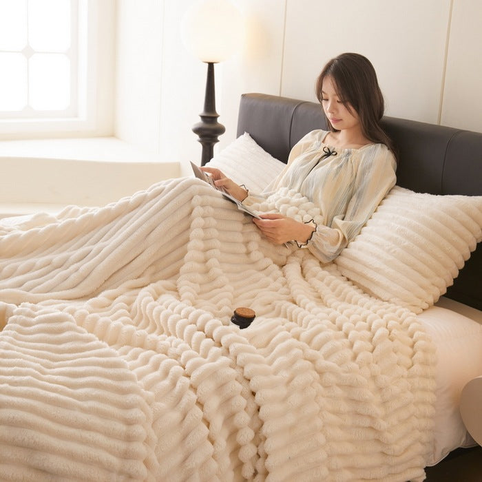 Dusty rose ribbed faux fur blanket on bed