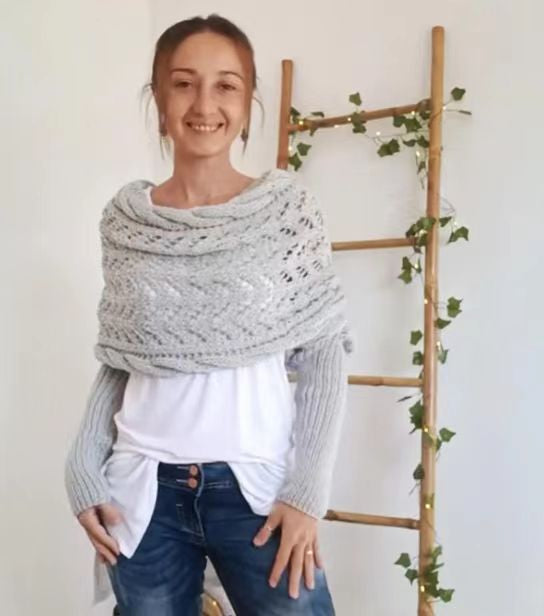 Woman in knitted shrug shawl with sleeves