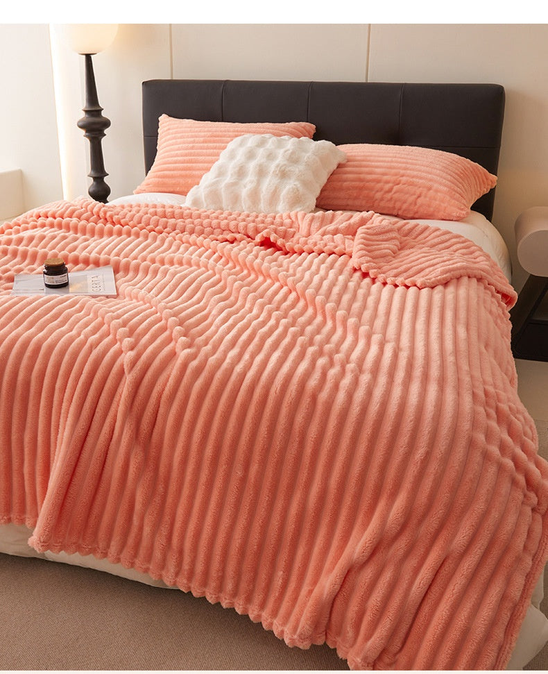 Dusty rose ribbed faux fur blanket on bed