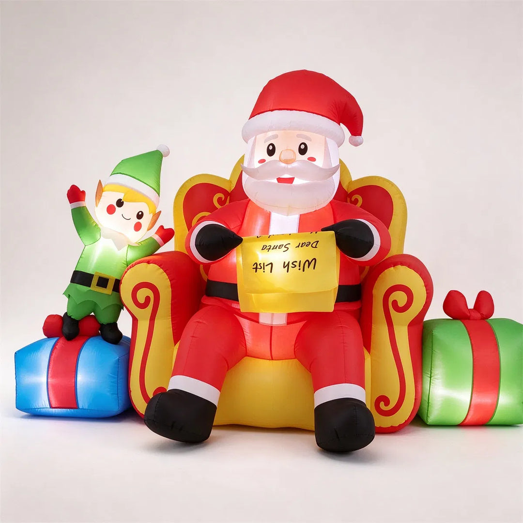 Inflatable Santa on sofa with elf