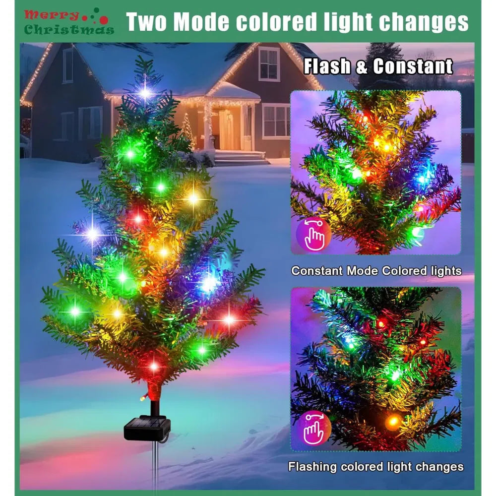 Four solar mini Christmas trees lit on lawn
