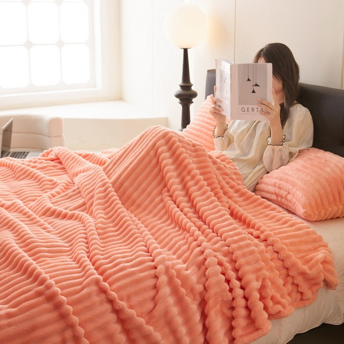 Dusty rose ribbed faux fur blanket on bed