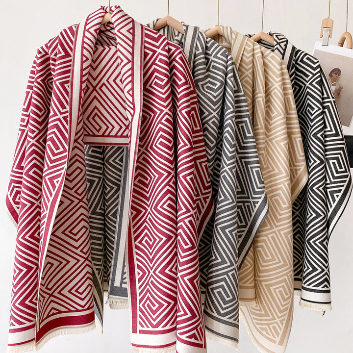 Woman wearing grey fringed shawl cape