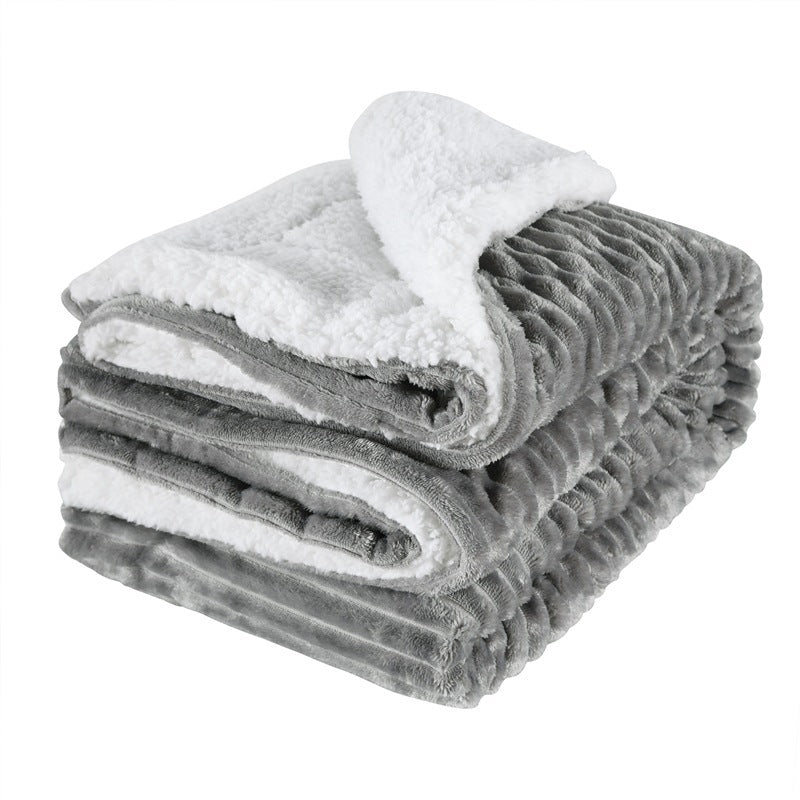 Thick sherpa blanket folded on a sofa