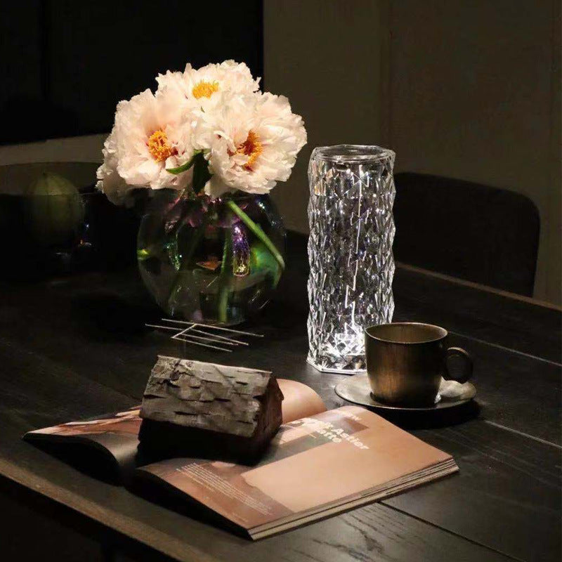 Crystal rose lamp glowing on bedside