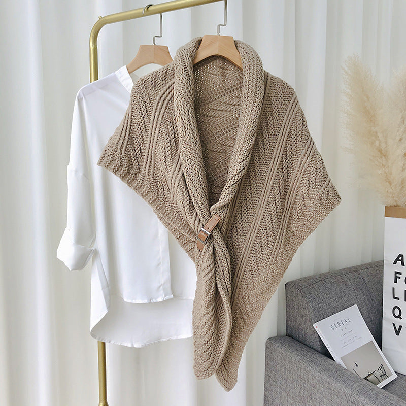 Woman in chunky knit triangle scarf with buckle