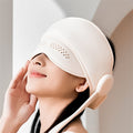 Person wearing hooded head massager wrap