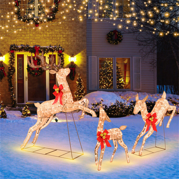 Three glitter reindeer with red bows lit