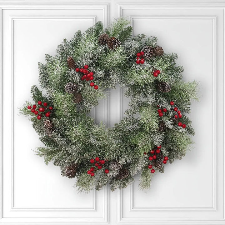 Lit wreath with pine cones and red berries