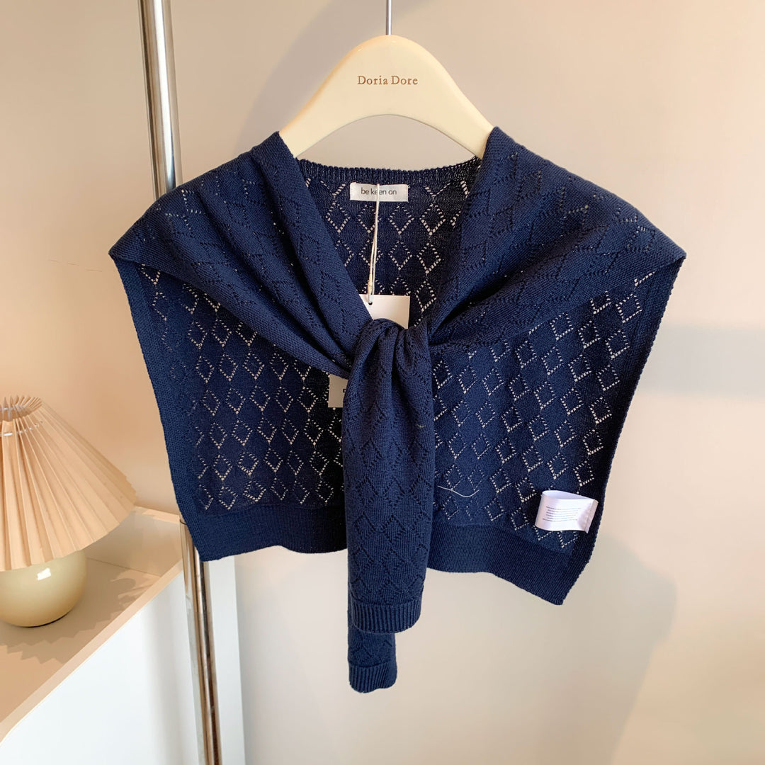 Woman wearing knitted tie front shoulder wrap