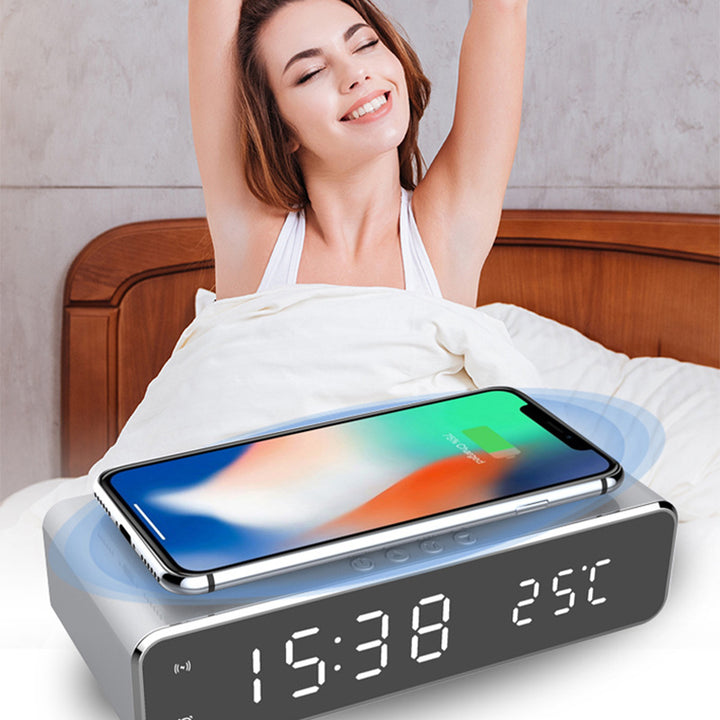 Mirror LED alarm clock charging a phone