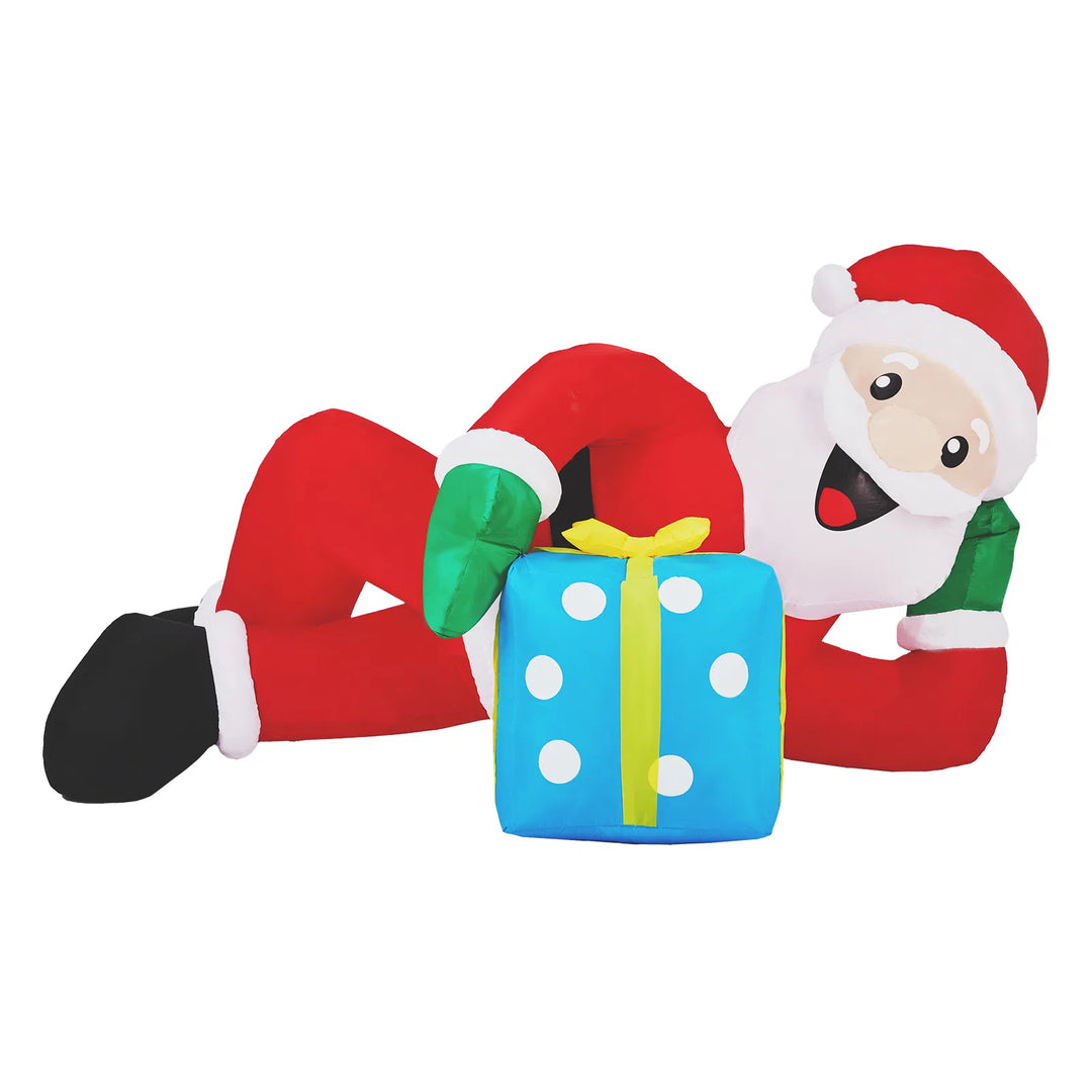 Inflatable Santa lying beside a gift box