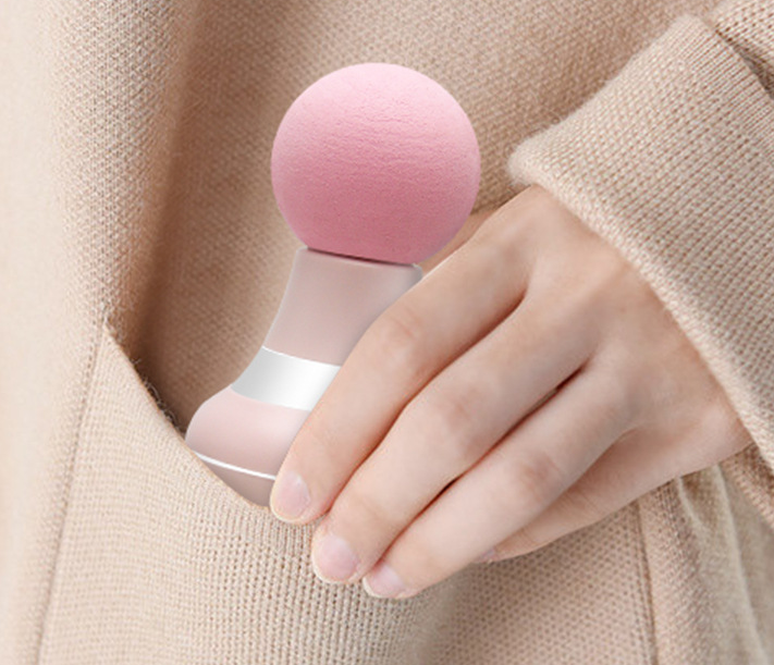 Mini pocket massage gun in hand