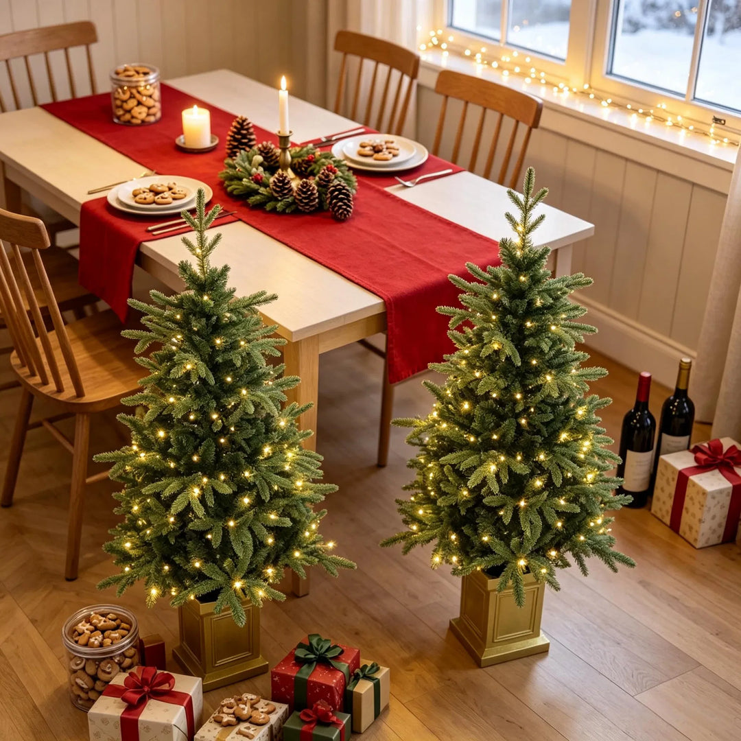 Two potted fir trees in gold pots