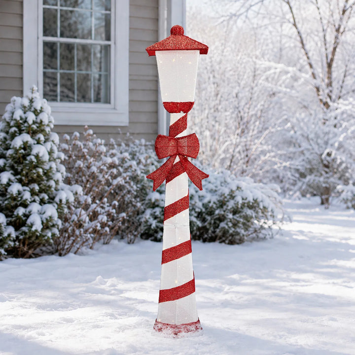 Candy cane striped Christmas lamp post glowing